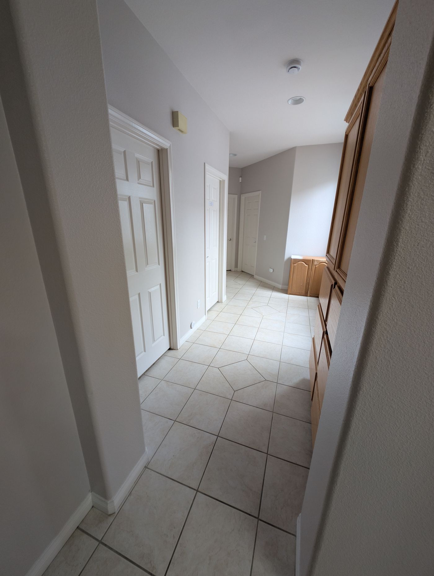 Hallway to three resident bedrooms, bathroom, medication cabinet and laundry — Soleil Levant Care